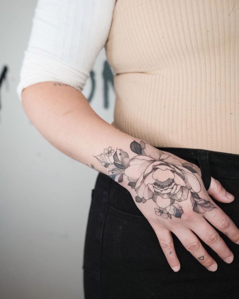 Floral hand tattoo on wrist