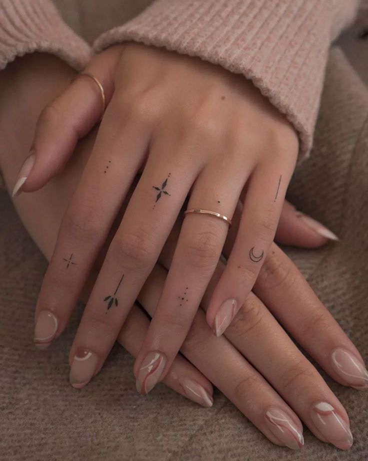 Elegant hands with minimalist tattoos.