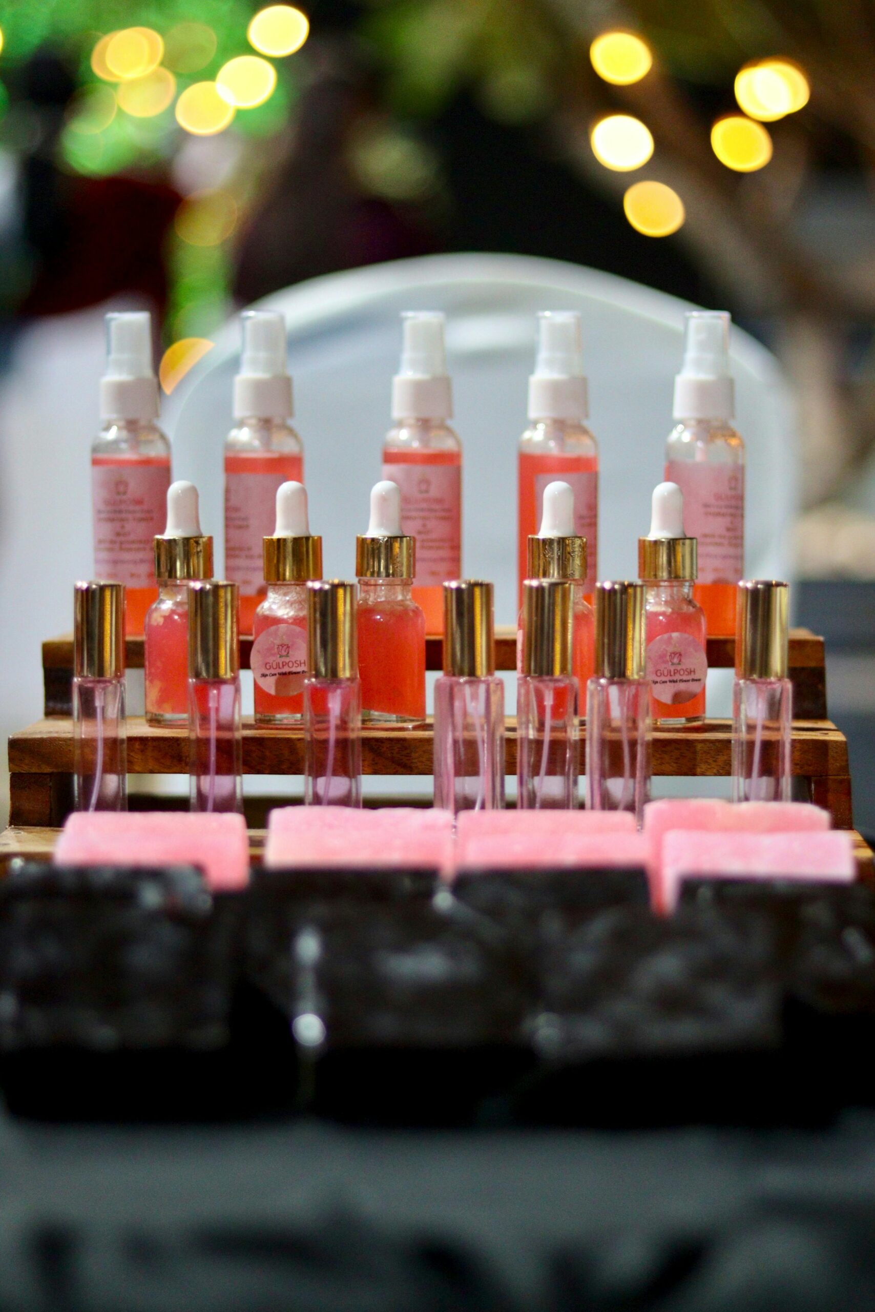 Chic arrangement of pink perfumes and soaps on display, perfect for beauty promotions.